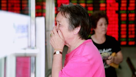 An investor reacts inside a brokerage firm on July 8, 2015 in Shanghai, China.