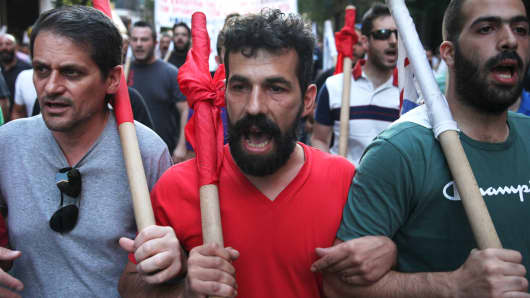 Anti-Euro protesters march through the streets during an anti-austerity rally in Athens, Greece July 15, 2015.