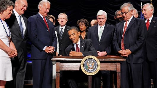 President Barack Obama signs the the financial reform bill into law July 21, 2010.