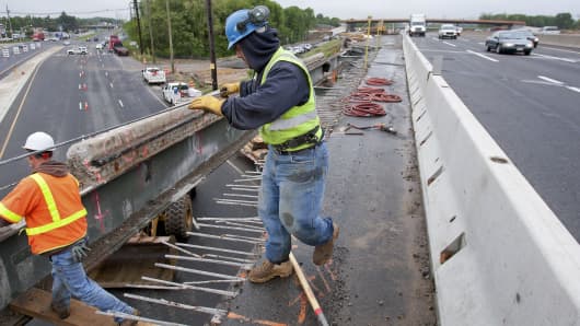 Workers extend an overpass on the New Jersey Turnpike in Bordentown.