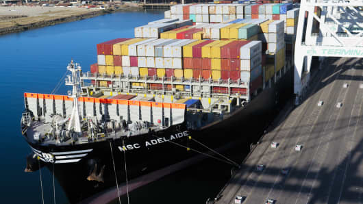 A cargo ship is loaded with shipping containers at the Port of Long Beach, Calif.