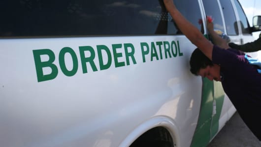 Border Patrol agents detain undocumented immigrants after they crossed the border from Mexico into the United States on August 7, 2015, in McAllen, Texas.