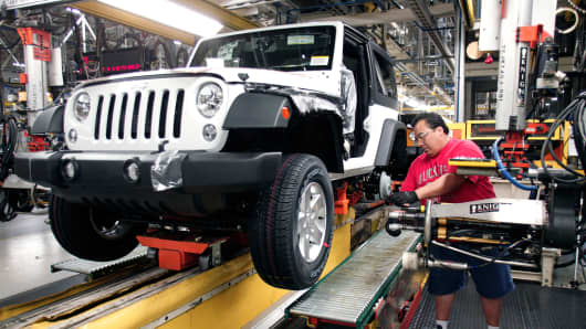 A worker installs tires on a Jeep Wrangler at the Chrysler Toledo North Assembly Plant in Toledo, Ohio.