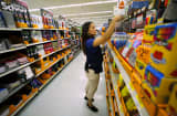 A Walmart department manager helps stock shelves with school supplies in San Diego, California August 6, 2015.