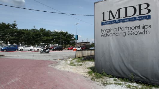 Signage for 1Malaysia Development Bhd. (1MDB) is displayed at the site of the Tun Razak Exchange (TRX) project in Kuala Lumpur, Malaysia.