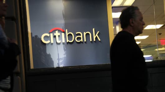 Pedestrians pass in front of a Citibank branch in New York.