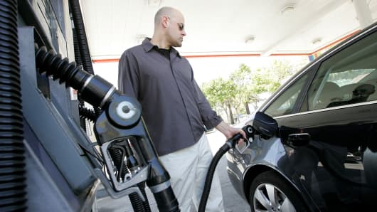 A customer pumps gasoline into his car at a service station in San Francisco.