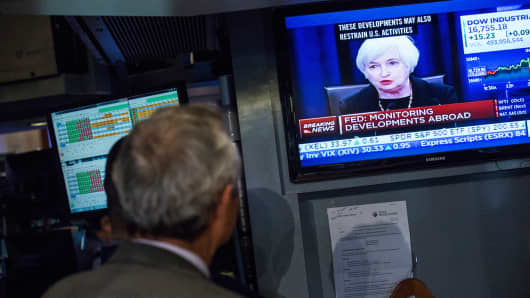 A trader works on the floor of the New York Stock Exchange while Federal Reserve Chairwoman Janet Yellen explains why the Federal Reserve chose not raise interest rates on September 17, 2015 in New York.