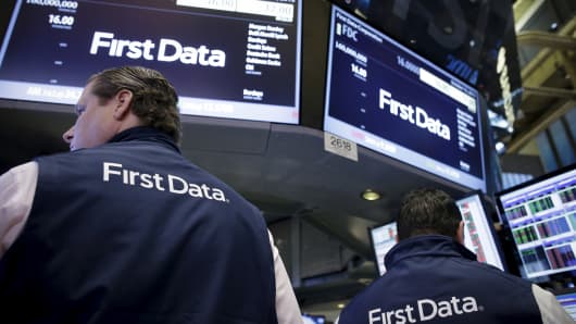 Traders work at the post that trade First Data stocks during the company's initial public offering on at the New York Stock Exchange on Oct. 15, 2015.