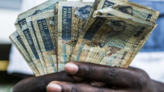 A man holds Zambian 50 kwacha banknotes in Lusaka on Oct. 8, 2015.