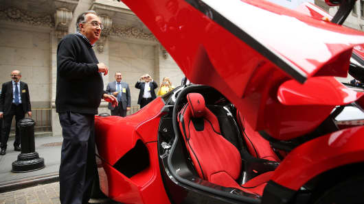 Sergio Marchionne, Chief Executive Officer, Fiat Chrysler Automobiles is viewed next to a Ferrari after ringing the Closing Bell on the floor of the New York Stock Exchange (NYSE) on October 13, 2014 in New York City.