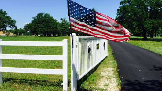 American flag and white fence