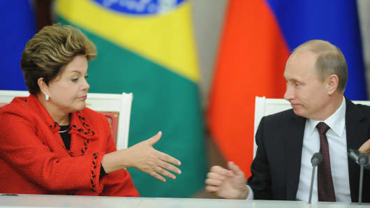Russia's President Vladimir Putin, right, and his visiting Brazil's counterpart Dilma Rousseff shake hands during their meeting in Moscow.