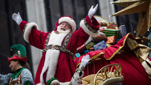 Santa Claus waves to the crowd during the Macy's Thanksgiving Day Parade on November 27, 2014 in New York City.