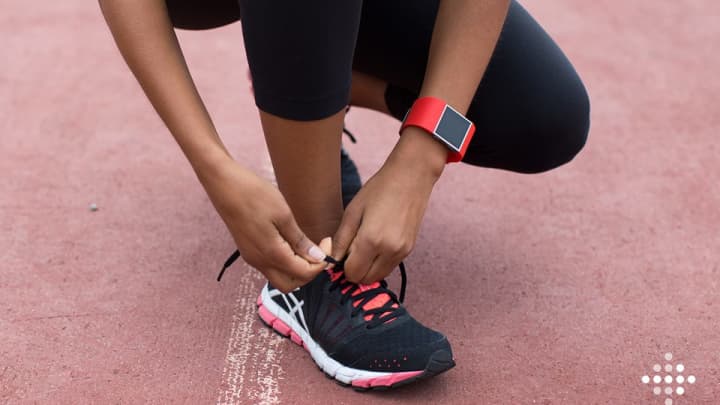 A runner wearing a Fitbit.