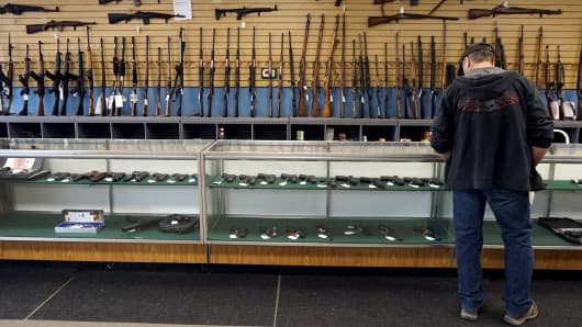 A customer looks over weapons for sale at the Pony Express Firearms shop in Parker, Colorado December 7, 2015.