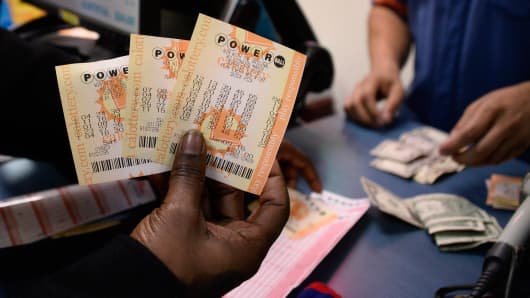 A customer shows purchased tickets for the Powerball lottery at a lotto store in San Bernardino County, California, January 9, 2016.