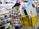 A customer uses her mobile phone as she shops at a Best Buy in Skokie, Ill.