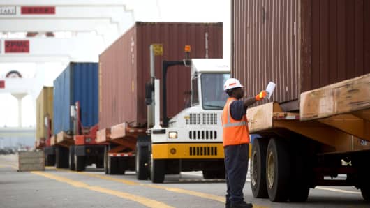 A spotter lines up a truck before a container is loaded from a ship in the Seagirt Marine Terminal at the Port of Baltimore.