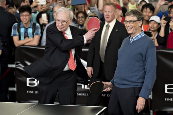 Warren Buffett, chairman of Berkshire Hathaway Inc. (left), plays pingpong with Bill Gates, chairman and founder of Microsoft Corp. and a Berkshire Hathaway Inc. director, at the Berkshire Hathaway annual shareholder meeting in Omaha, Nebraska, on May 3, 2015.