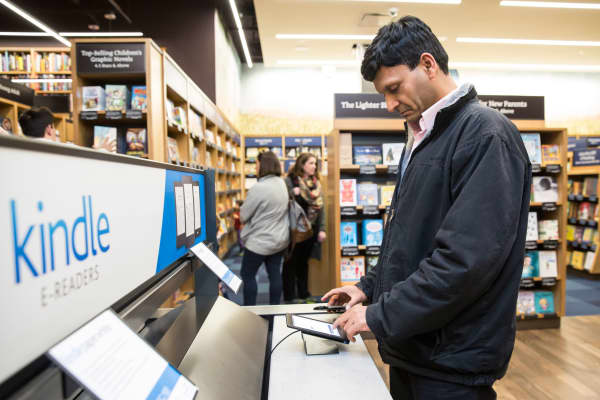 A customer uses a Kindle table device at the Amazon Books store in Seattle, Washington.