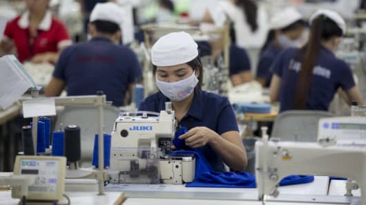 Workers sew clothing with sewing machines at the Esquel Group garment factory at the Vietnam-Singapore Industrial Park in Thuan An, Binh Duong province, Vietnam.