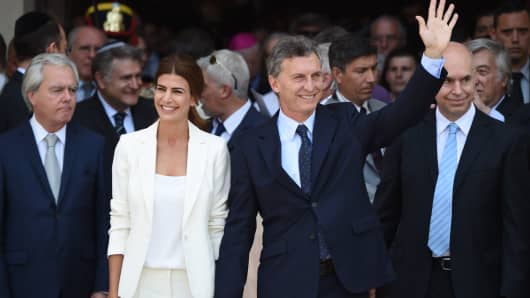 Argentina's President Mauricio Macri (R) and his wife, first lady Juliana Awada leave the Metropolitan Cathedral after attending a Te Deum in Buenos Aires on December 11, 2015.