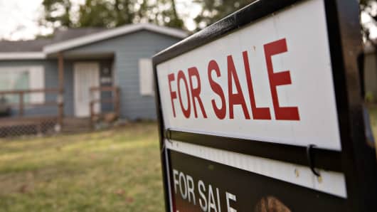 A 'For Sale' sign stands outside a home in Peoria, Illinois.