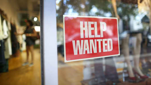 A help wanted sign in the window of the Unika store in Miami, Florida.