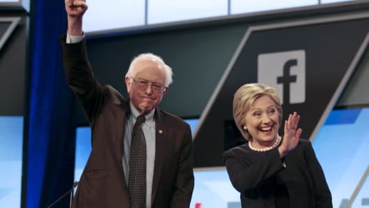 Democratic U.S. presidential candidates Senator Bernie Sanders and Hillary Clinton wave before the start of the Univision News and Washington Post Democratic U.S. presidential candidates debate in Kendall, Florida, March 9, 2016.