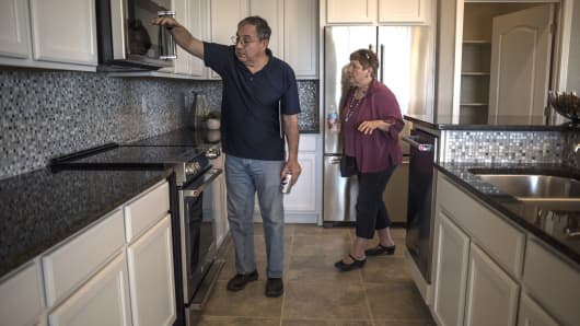 Prospective home buyers view a kitchen while touring a model home at the PulteGroup Inc. Mirehaven housing development in Albuquerque, New Mexico.