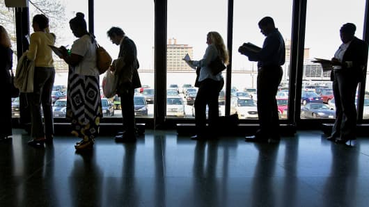 Job seekers stand in a line at a career fair in Chicago.