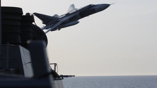 A U.S. Navy picture shows what appears to be a Russian Sukhoi SU-24 attack aircraft making a very low pass close to the U.S. guided missile destroyer USS Donald Cook in the Baltic Sea in this picture taken April 12, 2016 and released April 13, 2016.