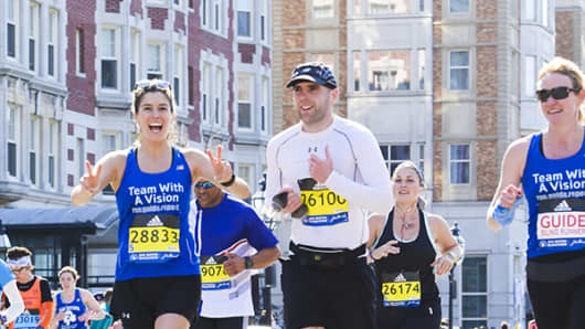 Simon Wheatcroft (middle) runs the Boston Marathon in 2016