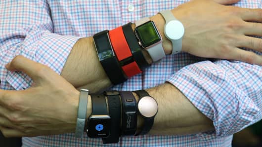A variety of wearable fitness devices on display. 