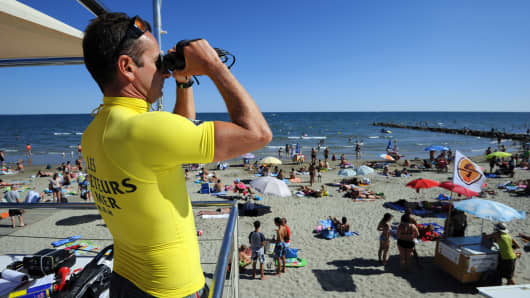 Lifeguard on beach with binoculars 
