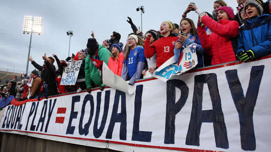 USA fans with an 'Equal Play Equal Pay' banner supporting the women players fight for equal pay with their male counterparts during the USA Vs Colombia