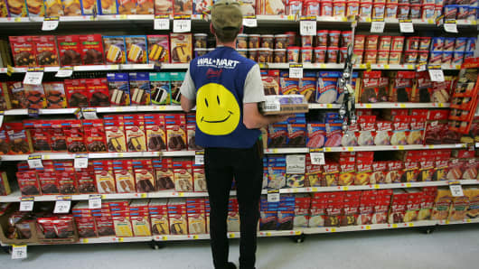 An employee restocks a shelf in the grocery section of a Wal-Mart Supercenter