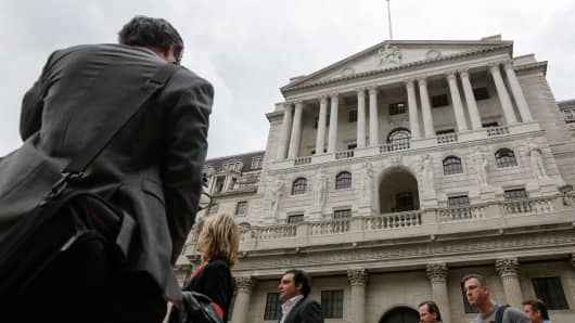 Pedestrians walk past the Bank of England (BOE) in the City of London, U.K.