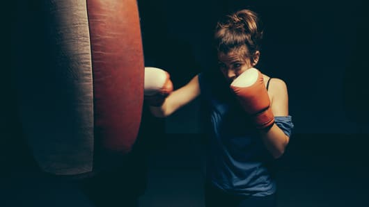 boxer exercising at punch bag