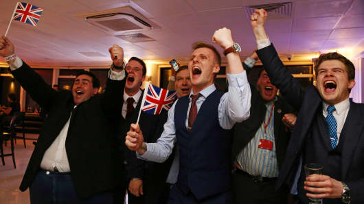 Leave.EU supporters wave Union flags and cheer as the results come in at the Leave.EU referendum party at Millbank Tower in central London early in the morning of June 24, 2016.