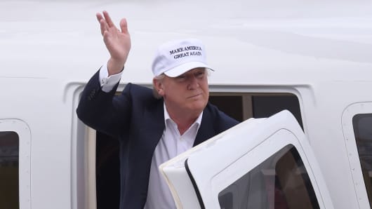 Republican presidential candidate Donald Trump waves as he arrives at his Turnberry golf course, in Turnberry, Scotland, Britain June 24, 2016.