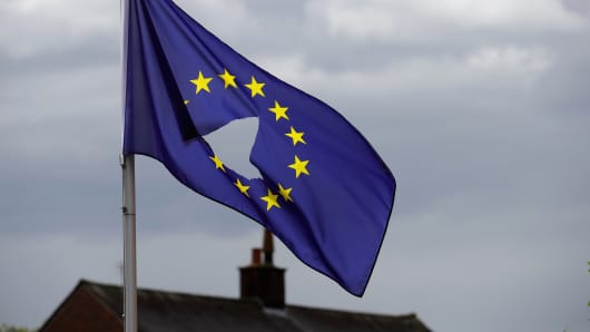 A European Union flag, with a hole cut in the middle, flies at half-mast outside a home in Knutsford Cheshire after today's historic referendum on June 24, 2016 in Knutsford, United Kingdom.