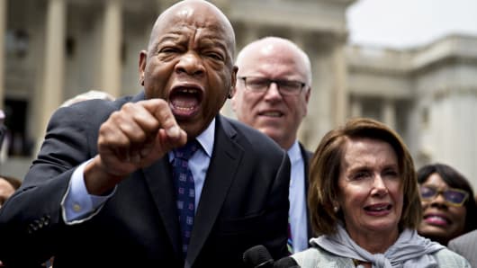 Representative John Lewis, a Democrat from Georgia, from left, speaks while standing next to Representative Joseph 'Joe' Crowley, a Democrat from New York, and House Minority Leader Nancy Pelosi, a Democrat from California, outside the U.S. Capitol in Washington, D.C., June 23, 2016.