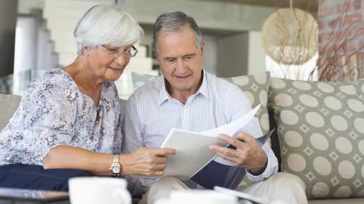 Couple reading documents, retirees