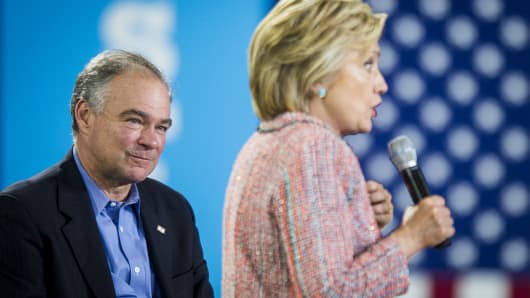 Sen. Tim Kaine, a Democrat from Virginia, listens while Hillary Clinton speaks during a campaign event at Northern Virginia Community College in Annandale, Va.