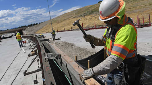 Sergio Hernandez works on the median just east of the new I-25 interchange in Castle Rock, Colorado.