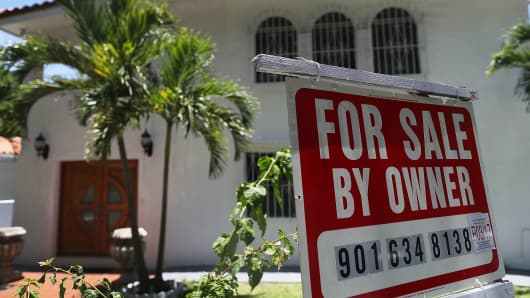 A for sale sign is seen in front of a home in Miami, Florida.