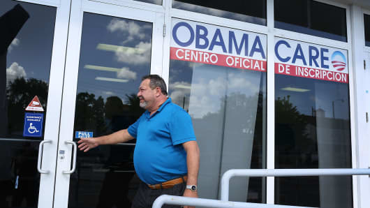 A person walks into the UniVista Insurance company office where people are signing up for health care plans under the Affordable Care Act, also known as Obamacare, in Miami, Florida.
