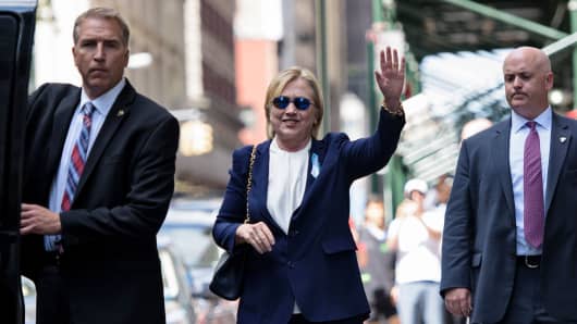 Hillary Clinton waves as she leaves her daughter's New York apartment building after resting there on Sept. 11, 2016.